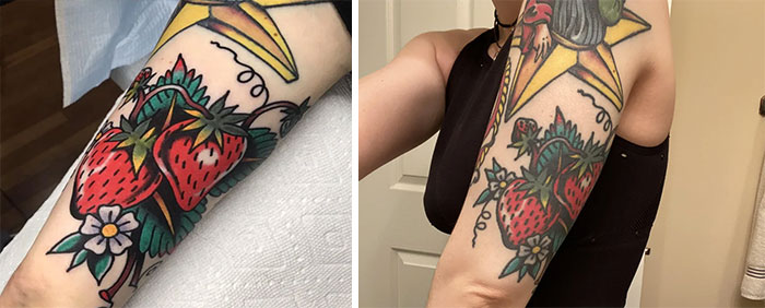 Aged tattoos showing faded and aged strawberry design on an arm.