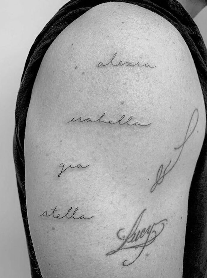 Celebrity tattoos featuring elegant script names on an arm.