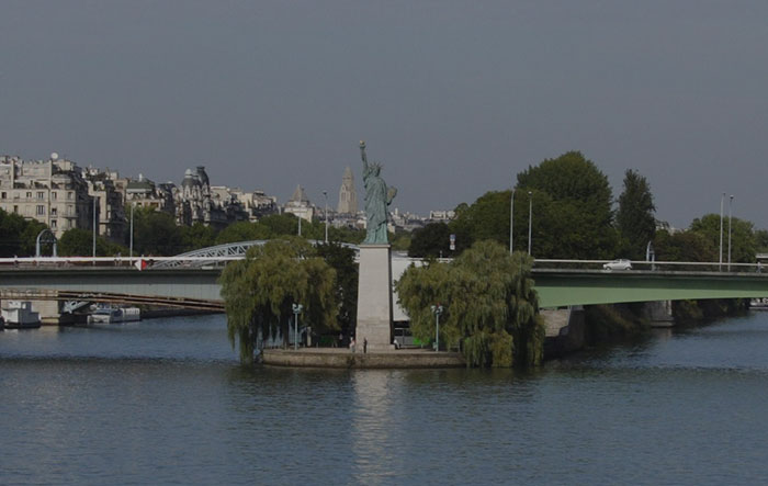 Statues Of Liberty near a bridge in Paris 