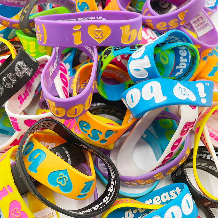 Colorful silicone bracelets with breast cancer awareness messages, showcasing big trends that we almost forgot existed.