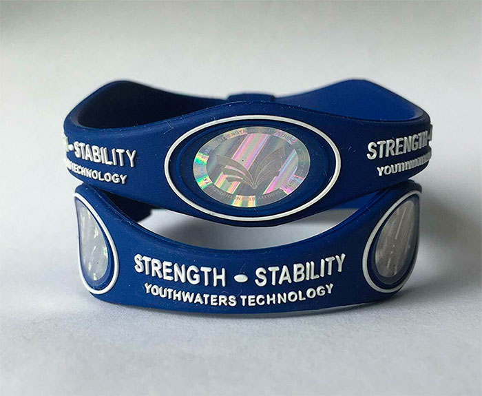 Blue strength and stability wristbands with holographic emblems, showcasing a forgotten big trend in wearable technology.