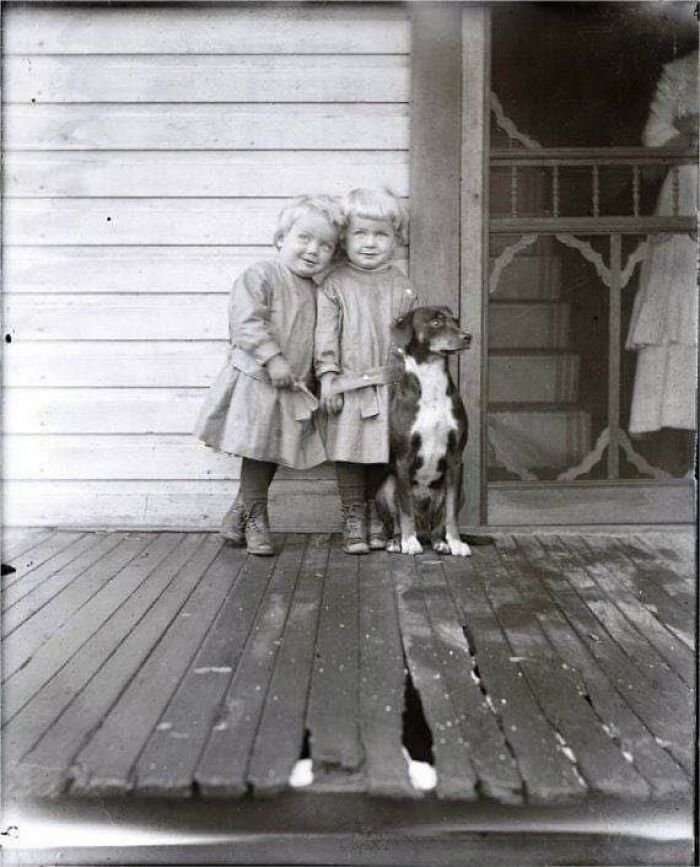 Little Twins With Their Dog On Porch