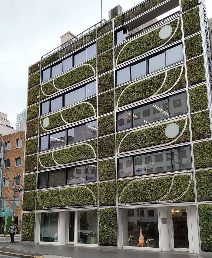 This Building In Tokyo With Plants Growing On The Walls