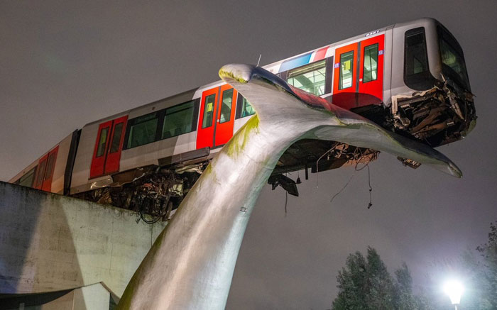 A Tram In The Netherlands Failed To Stop In Time And Broke Through The Emergency Barrier. It's Being Held Up By The Statue Of A Whale's Tail