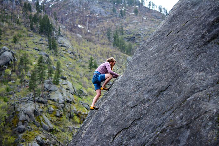 Man Rock Climbing Up The Hill 