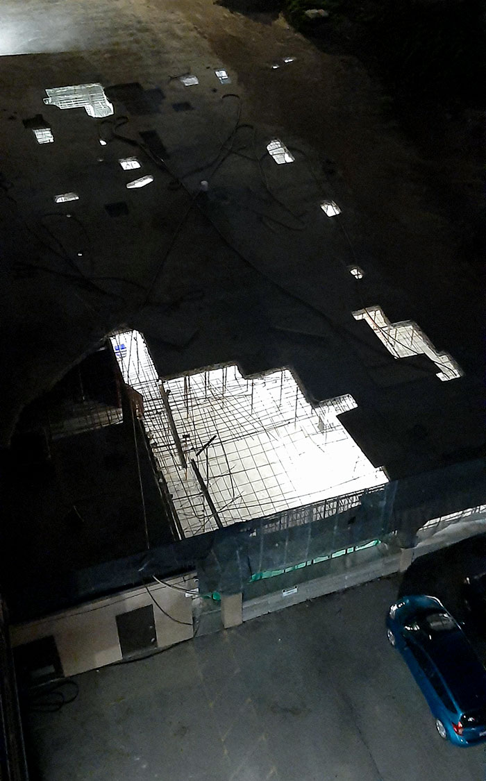 The Underground Parking Lot Is Getting A New Roof. At Night It Looks Like The Graphics Of A Video Game Are Not Loading