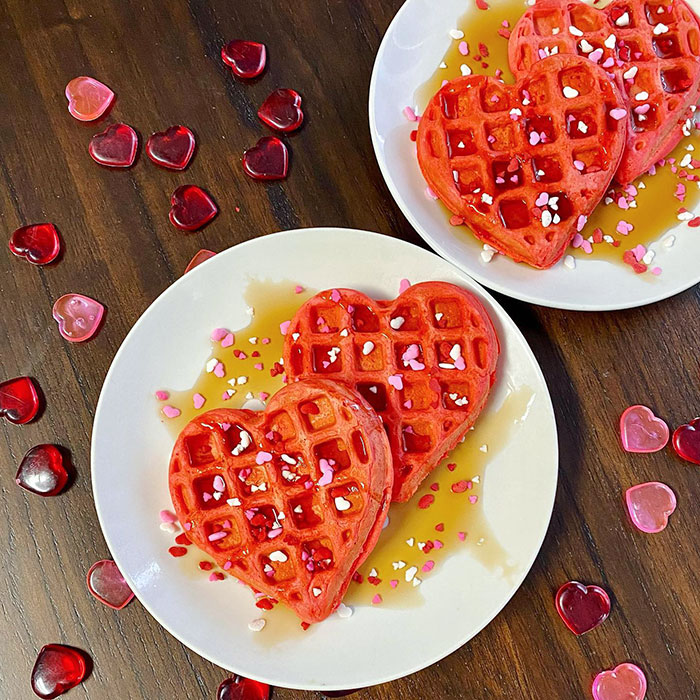 Happy Valentine's Day. Red Heart-Shaped Waffles With Lots Of Heart Sprinkles