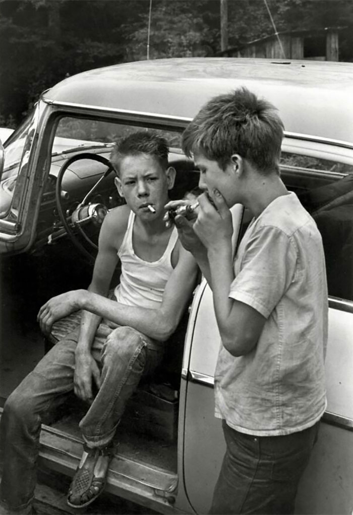 Cornett Boys Smoking By Car, Leatherwood, Kentucky, 1964, By William Gedney