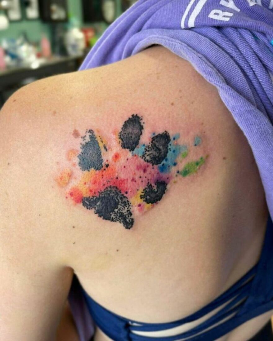 colorful paw print tattoo on the back