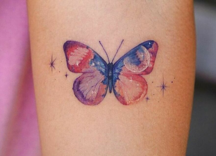 watercolor butterfly tattoo on the arm