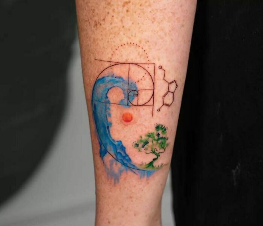 blue wave, red sun and green tree tattoo with abstraction tattoo on the arm