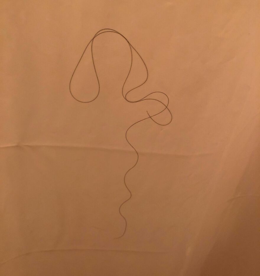 A Woman With Cascading Curly Hair Over Shoulder