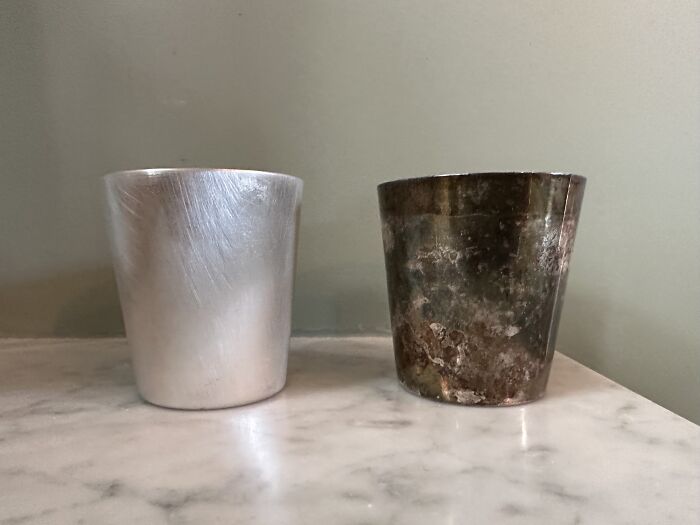 A Cleaned Silver Shot Glass Next To Its Tarnished Sibling