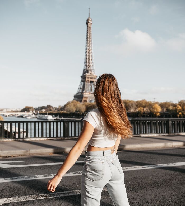 Woman posing on the road near the Eiffel tower 