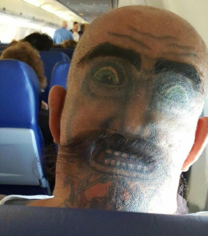 Funny Face Tattoo On The Back Of The Head 