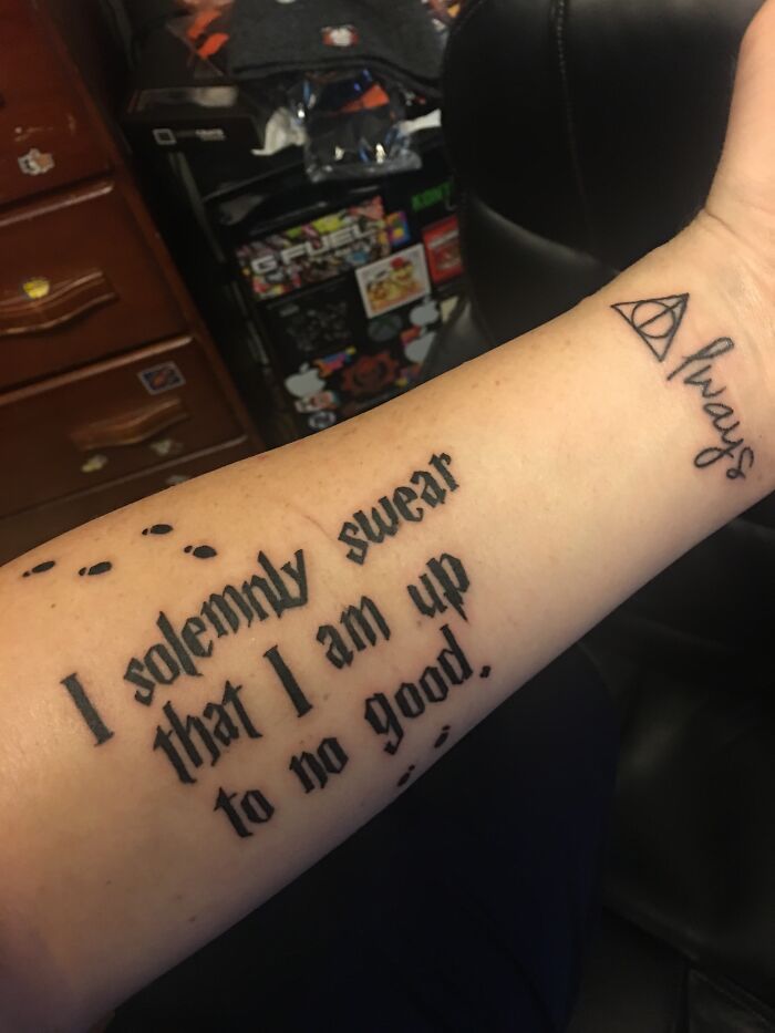 Tattoo on forearm with the words “I solemnly swear that I am up to no good” and a symbol with “always.”