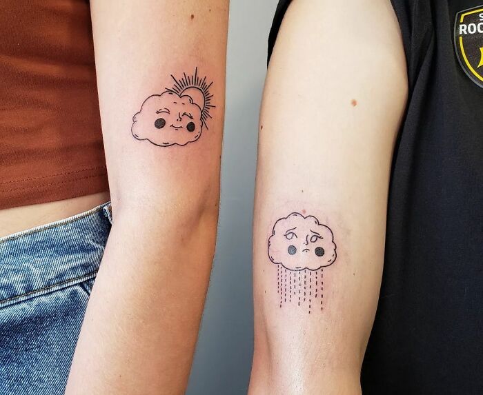 Matching cloud arm tattoos