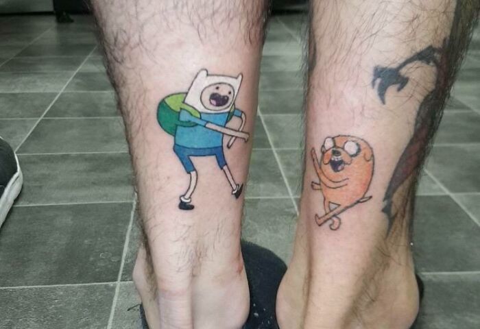 Finn and Jake from Adventure Time leg tattoos
