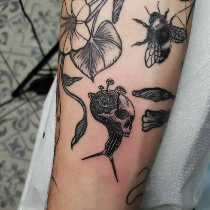 Small snail and mushroom hand tattoo