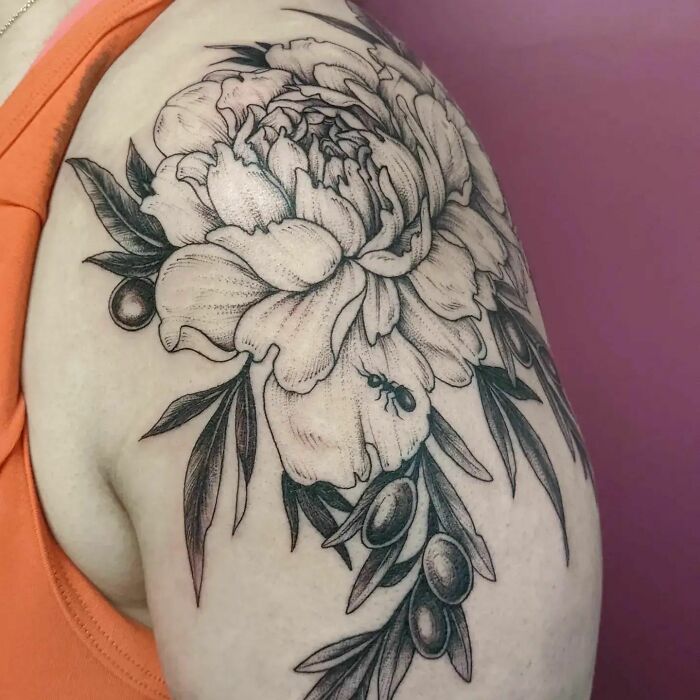 Nature tattoo of a detailed floral design with an ant, inked on an arm, showcasing wild side artistry.