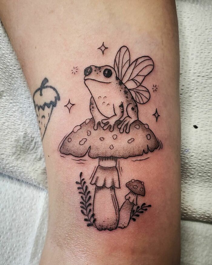 Tattoo of fairy frog on amanita mushroom