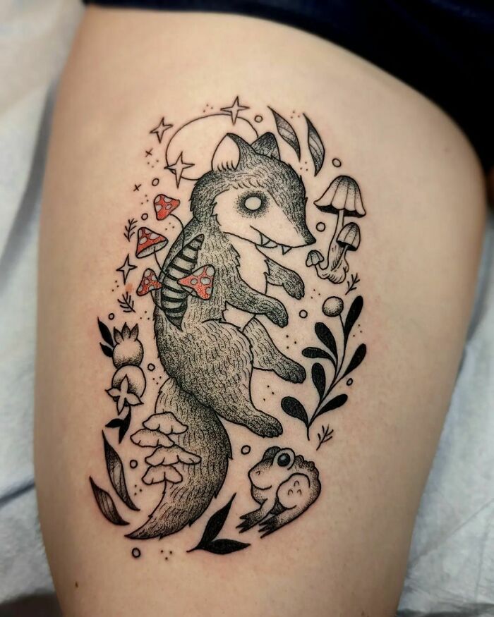 A playful nature tattoo featuring a fox, mushrooms, and leaves, capturing a whimsical, wild side design.