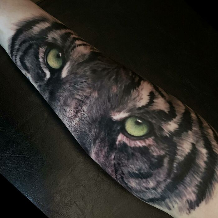 Green tiger eyes tattoo