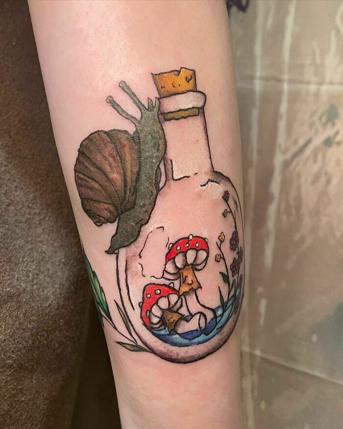 Snail And Bottle with mushroom arm tattoos 