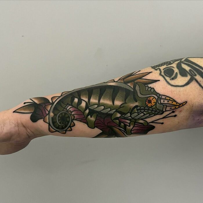 Colorful chameleon tattoo on forearm, showcasing a nature-inspired design for those with a wild side.