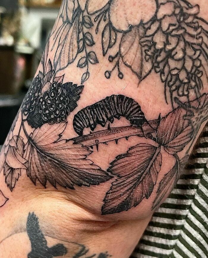 Caterpillar on a branch hand tattoo 