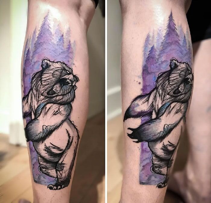 Sketchy black angry bear with purple watercolor pine trees in the background tattoo on leg