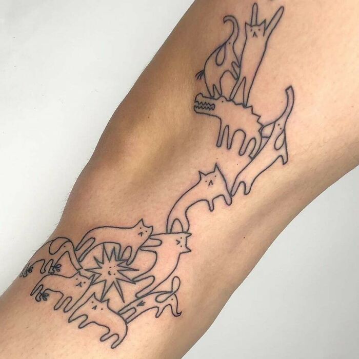 Minimalist animal tattoo featuring various line-drawn creatures on an arm, showcasing unique tattoo ideas.
