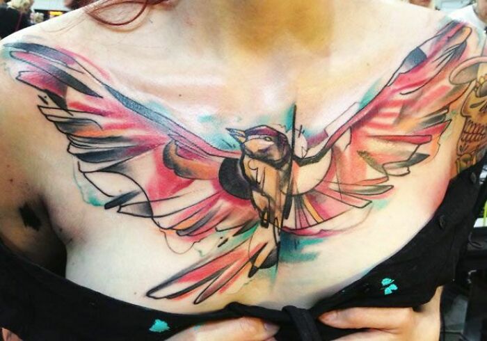 Abstarct color flying bird tattoo on chest