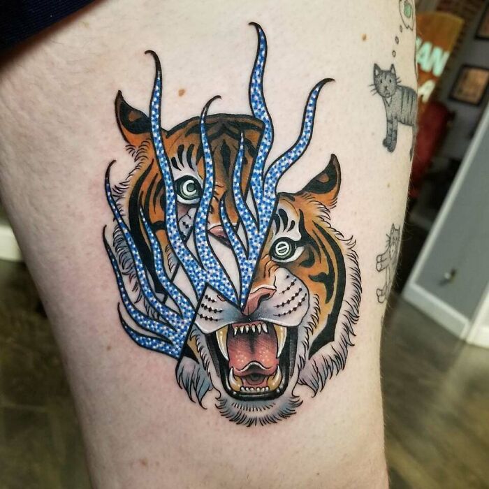 Broken in two pieces tiger face with blue flames tattoo 