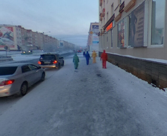 4 personas con trajes de protección de 4 colores en Norilsk, Rusia. Cuanto más se avanza en Street View, más extrañas resultan sus acciones, desde mirar fijamente a las paredes hasta comprobar buzones al azar