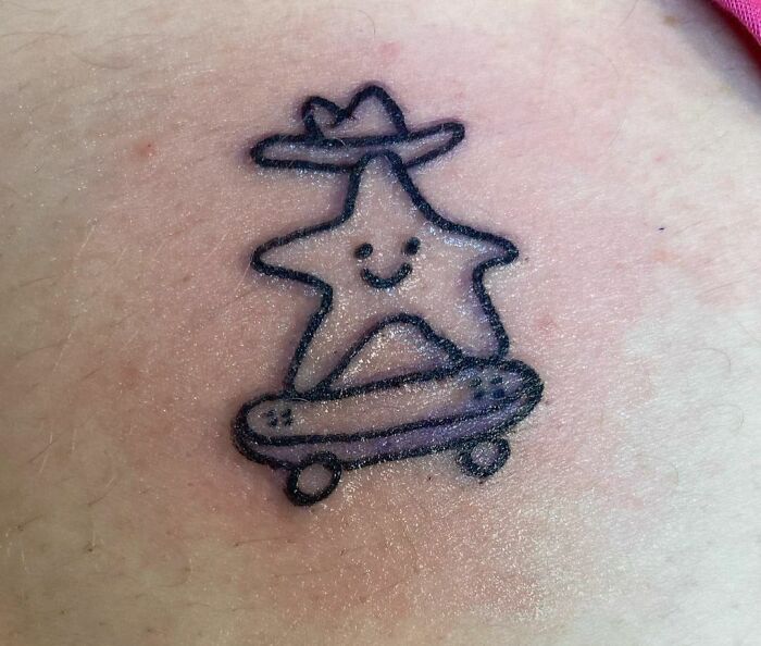 Small star on a skateboard tattoo 
