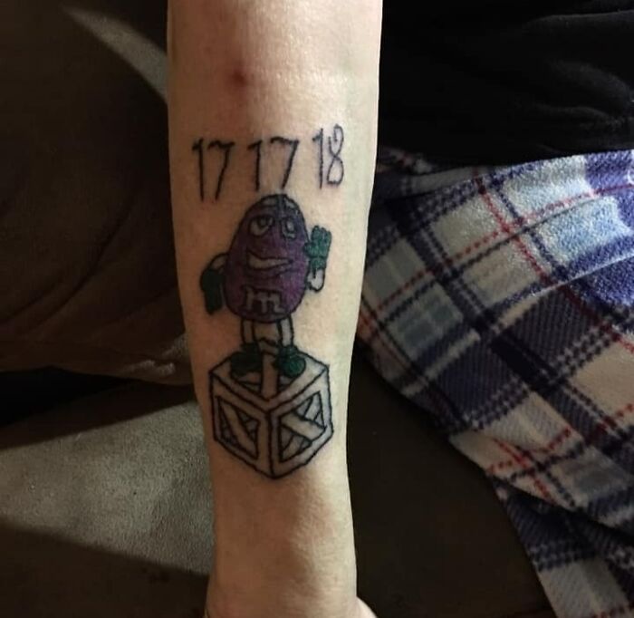 M&M candy on a box and numbers arm tattoo 