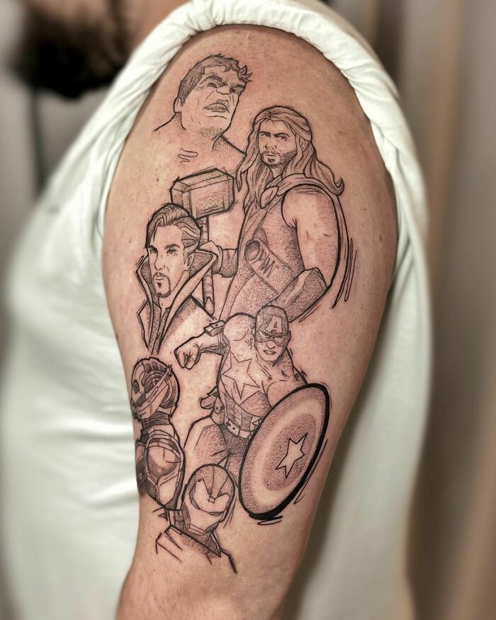 Marvel tattoos featuring superheroes, including Thor and Captain America, on a person's upper arm.