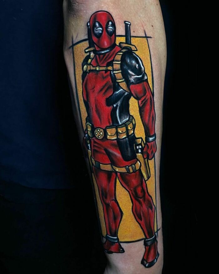 Marvel superhero Deadpool tattoo featuring a bold, colorful design on a forearm.