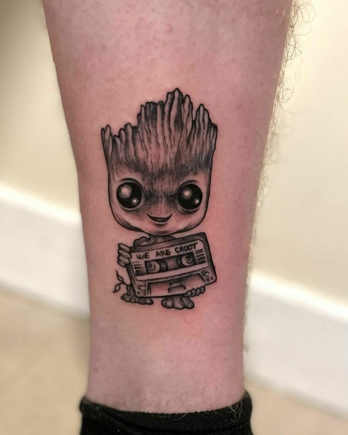 Little Groot holding mixtape and smiling 