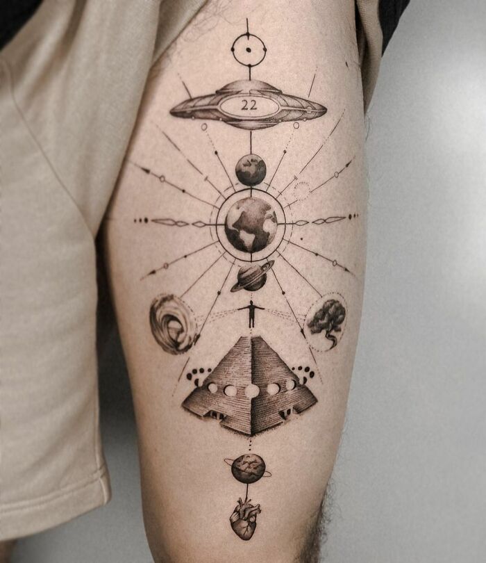Cosmic composition tattoo with planets, spaceship, pyramid, human figure and a heart