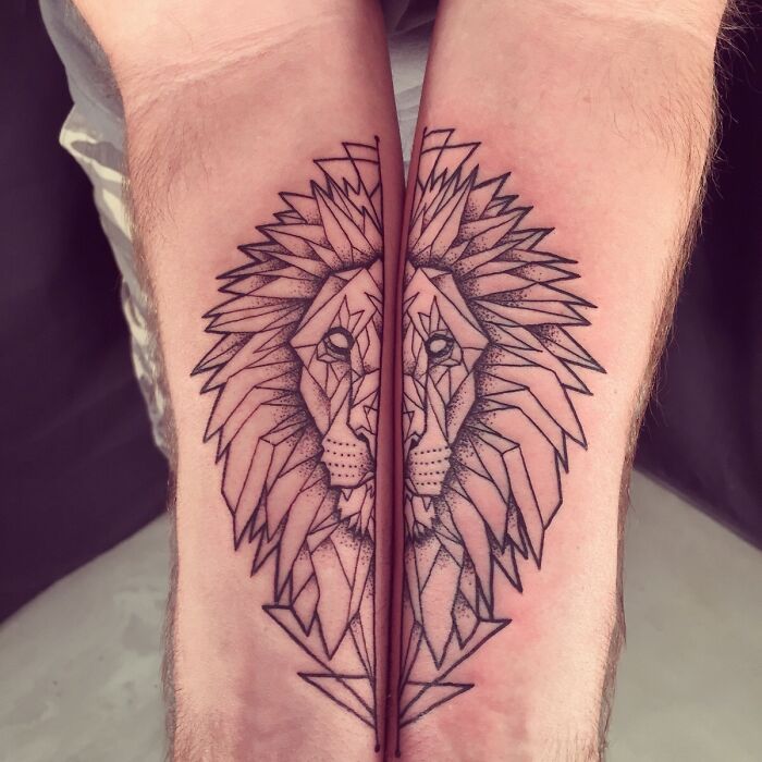 Geometric tattoos of a lion's face, intricately designed across forearms, highlighting creativity and symmetry.
