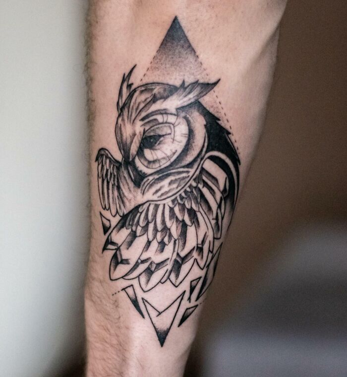 Geometric owl tattoo on forearm