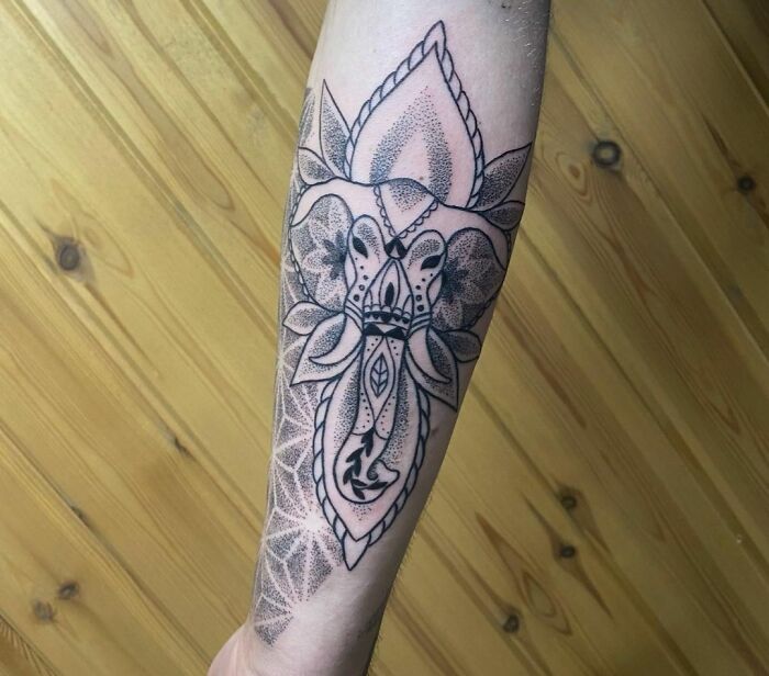 Geometric elephant face tattoo on arm