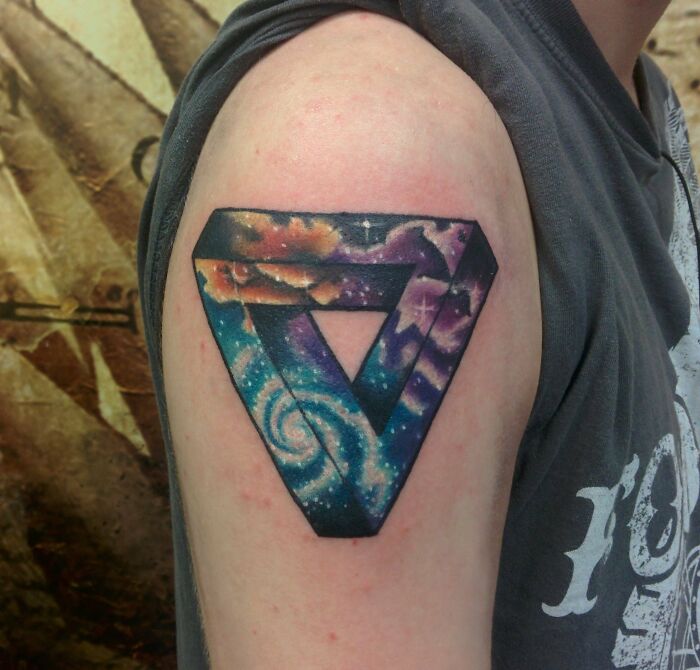 Penrose triangle with space fill tattoo on arm