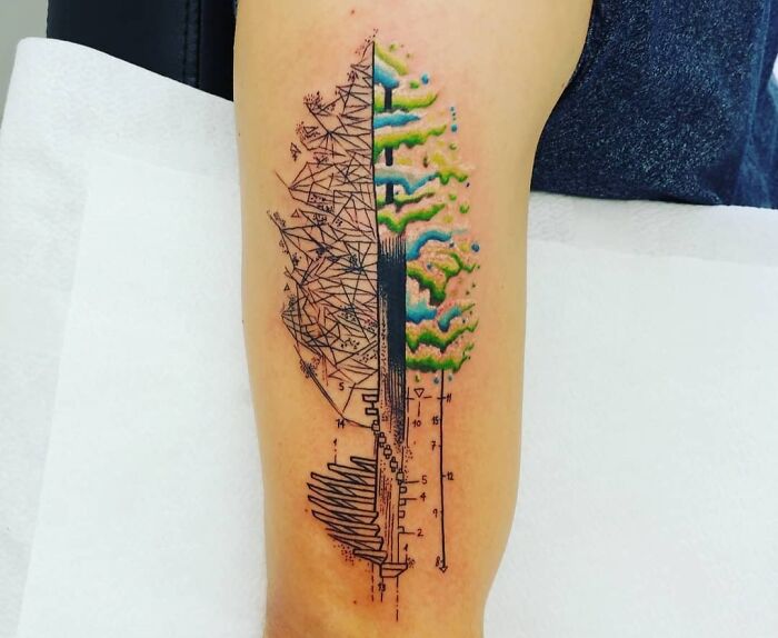 Geometric tattoo design on arm featuring intricate shapes and colorful patterns.