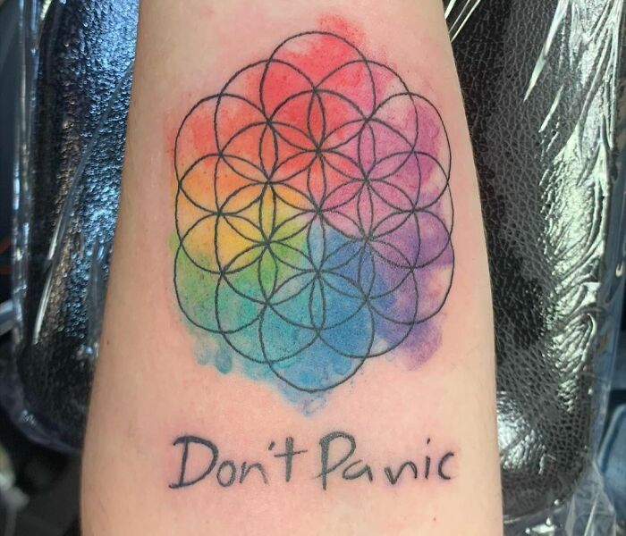 Flower of life geometric grid on watercolor with ‘Don't Panic’ tattoo