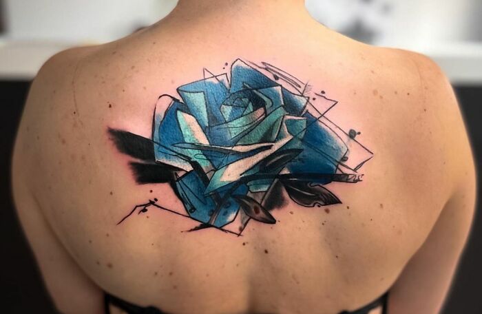 Geometric blue rose tattoo on back