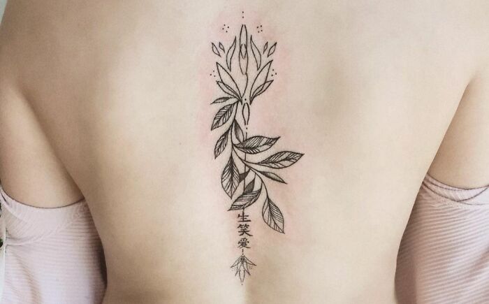Geometric flower spine tattoo