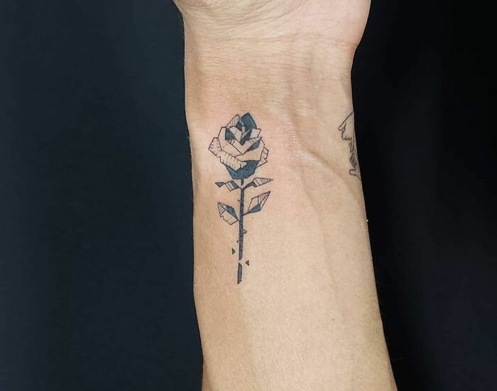 Geometric rose tattoo on arm